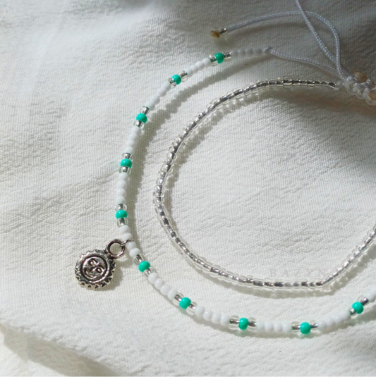 • Beaded pair bracelet with turquoise beads and sun charm

• Adjustable
